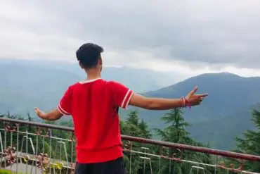 Person enjoying mountain view outdoors